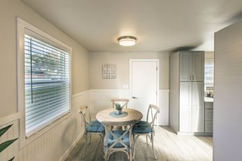 a small dining room with a table and chairs at The Lakes Apartments, Moses Lake Washington 